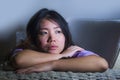 Young sad and depressed Asian Korean woman at home sofa couch crying desperate and helpless suffering anxiety and depression feeli Royalty Free Stock Photo