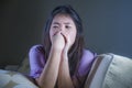 Young sad and depressed Asian Korean woman at home sofa couch crying desperate and helpless suffering anxiety and depression feeli Royalty Free Stock Photo