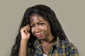 Young sad and depressed black African American woman crying anxious and overwhelmed feeling sick and stressed on studio b Royalty Free Stock Photo