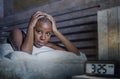 Young sad depressed black afro American woman awake on bed sleepless suffering insomnia sleeping disorder anxiety problem with ala Royalty Free Stock Photo