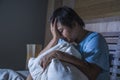 Young sad and depressed fat and chubby Asian girl feeling upset and desperate crying on bed at home victim of bullying and Royalty Free Stock Photo