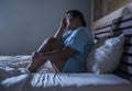 Young sad and depressed fat and chubby Asian girl feeling upset and desperate crying on bed at home victim of bullying and Royalty Free Stock Photo