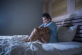 Young sad and depressed fat and chubby Asian girl feeling upset and desperate crying on bed at home victim of bullying and Royalty Free Stock Photo