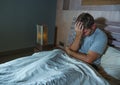 Young sad and depressed sleepless man lying on bed worried and thoughtful at home bedroom suffering depression problem feeling Royalty Free Stock Photo