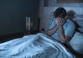 Young sad and depressed sleepless man lying on bed worried and thoughtful at home bedroom suffering depression problem feeling Royalty Free Stock Photo