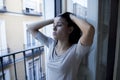 Desperate Latin woman at home balcony looking destroyed and depressed suffering depression