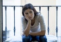 Desperate Latin woman sitting at home balcony looking destroyed and depressed suffering depression Royalty Free Stock Photo