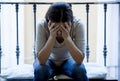 Desperate Latin woman sitting at home balcony looking destroyed and depressed suffering depression Royalty Free Stock Photo