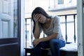 Desperate Latin woman sitting at home balcony looking destroyed and depressed suffering depression Royalty Free Stock Photo