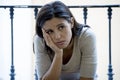 Desperate Latin woman sitting at home balcony looking destroyed and depressed suffering depression Royalty Free Stock Photo