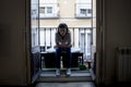 Desperate sad Latin woman at home balcony looking devastated and depressed suffering depression Royalty Free Stock Photo