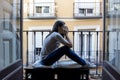 Desperate sad Latin woman at home balcony looking devastated and depressed suffering depression Royalty Free Stock Photo