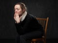 Young sad disoriented woman sitting on the chair Royalty Free Stock Photo