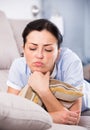 Young sad female lying on cozy sofa Royalty Free Stock Photo