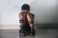 Young sad and scared hispanic kid 8 years old in school uniform sitting alone crying depressed and frightened suffering abuse pro Royalty Free Stock Photo