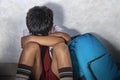 Young sad scared kid 8 years old in school uniform and backpack sitting alone crying depressed and frightened suffering abuse prob Royalty Free Stock Photo