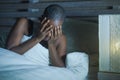 Young sad and stressed black afro American woman lying on bed upset trying to sleep suffering insomnia and depression feeling anxi Royalty Free Stock Photo