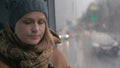 Young sad woman in the bus on a dull rainy day