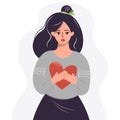 Young sad woman holding a red heart in her hands. Symbol of support, love everywhere. Girl with a heart in her hands.The