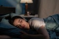 Young sad woman lying in bed late at night trying to sleep suffering insomnia. Girl in bed scared on nightmares looking Royalty Free Stock Photo