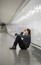 young sad woman in pain alone and depressed at urban subway tunnel ground worried suffering depression Royalty Free Stock Photo