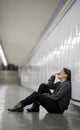 young sad woman in pain alone and depressed at urban subway tunnel ground worried suffering depression Royalty Free Stock Photo