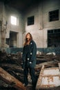 Young sad woman stands in the abandoned building Royalty Free Stock Photo