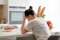 Young sad woman suffering in kitchen, Stressed housewife in kitchen Royalty Free Stock Photo