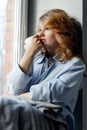 Young sad woman with tea cup. Royalty Free Stock Photo