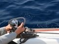 Young sailor on the winch in the sailboat cockpit. Royalty Free Stock Photo