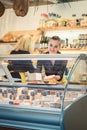 Young Sales lady at the cheese counter in a supermarket Royalty Free Stock Photo