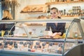 Young Sales lady at the cheese counter in a supermarket Royalty Free Stock Photo