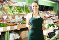 Salesgirl in the vegetable department Royalty Free Stock Photo