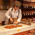 Young saleswoman cutting the turron in a shop in Seville