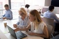 Young saleswoman mentor consulting old client employee pointing at laptop Royalty Free Stock Photo