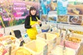 a young saleswoman selling Siberian honey at the city fair. The text in Russian: clover, kiprei, linden, honey, and other names of