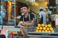 Young saller of fresh boiled corn, popular street food