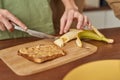 Young same sex male couple cutting banana on toast Royalty Free Stock Photo