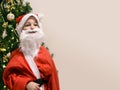 Young Santa Claus cute boy front Christmas tree copy space template greeting card Royalty Free Stock Photo