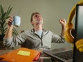 Young satisfied and confident business man excited gesturing on victory as a winner working at home office with laptop computer on Royalty Free Stock Photo