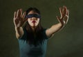 Young scared and blindfolded Asian Chinese teenager girl lost and confused playing dangerous internet viral challenge on