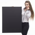 Young scared woman showing presentation, pointing on placard Royalty Free Stock Photo
