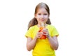 Young school age child girl holding a glass bottle full of juice in hands in front of her, one person isolated on white background Royalty Free Stock Photo