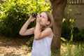 Young school age child, girl looking up into the sky through a magnifying monocular watching birds, searching seeking looking for Royalty Free Stock Photo