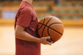 Young School Boy Holding Basketball Ball in Hands at Training Game. Junior Basketball Players on a Game Royalty Free Stock Photo