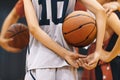 Young School Boy Holding Basketball Ball and Listening To Coach at Training Game. Junior Basketball Players in Practice Game Royalty Free Stock Photo