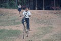 Young school boy riding bike, Bakong Temple, Cambodia