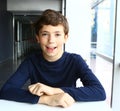 Young school boy sit in cafe smiling laughing Royalty Free Stock Photo