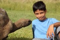 Young school boy sitting alongside giant tortoise