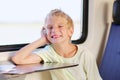 Young school boy in train with mobile phone Royalty Free Stock Photo